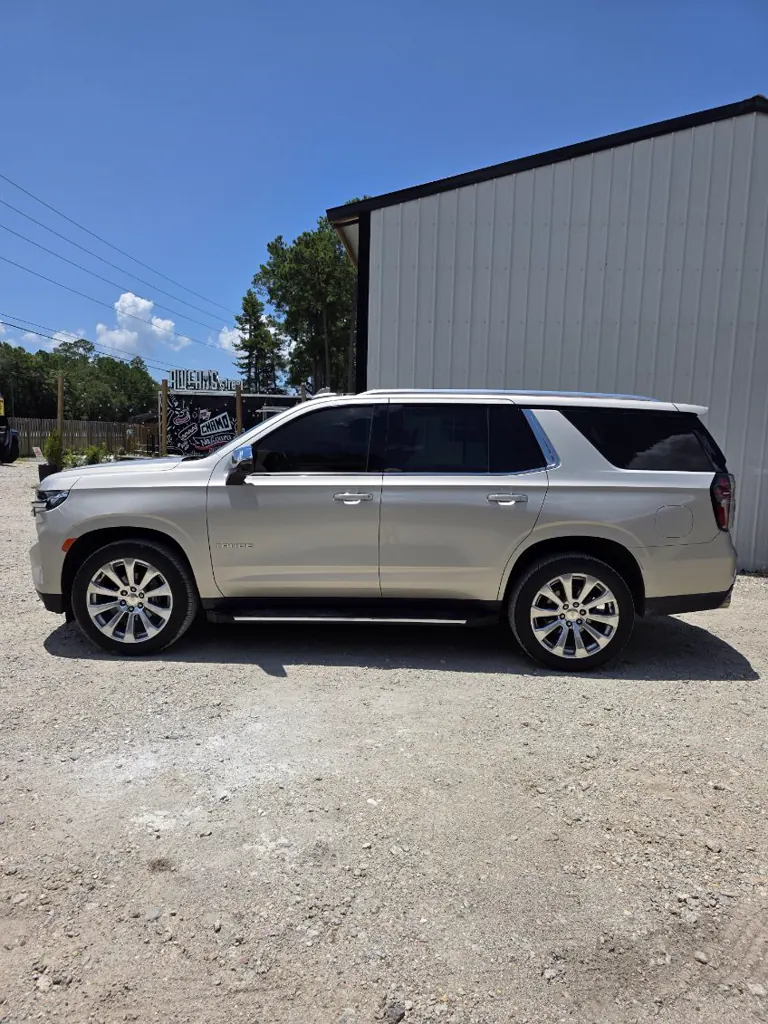 Champagne Cadillac Escalade with fresh window tint, clean side profile