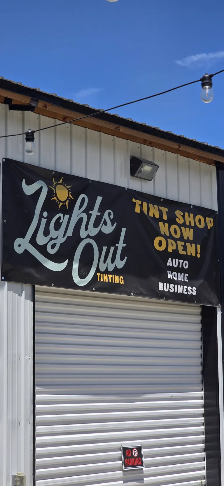 The hand-painted Lights Out Tinting shop sign in Freeport